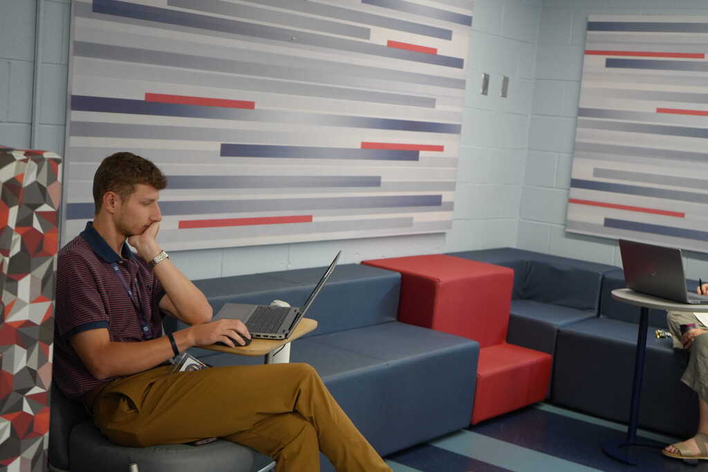 New Teacher Sitting, Working on Laptop