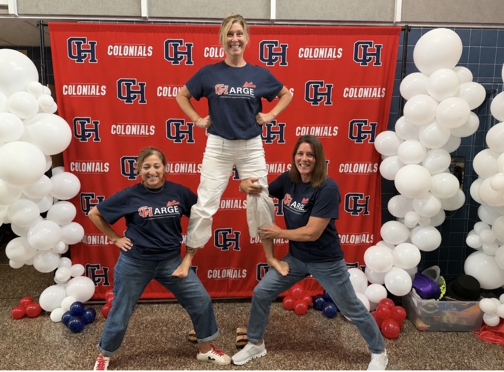 CHPS Staff in Cheerleading Positions in Front of CHPS Backdrop