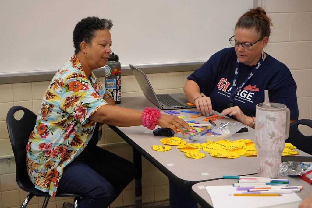 CHPS Teachers Learning Together at a Table