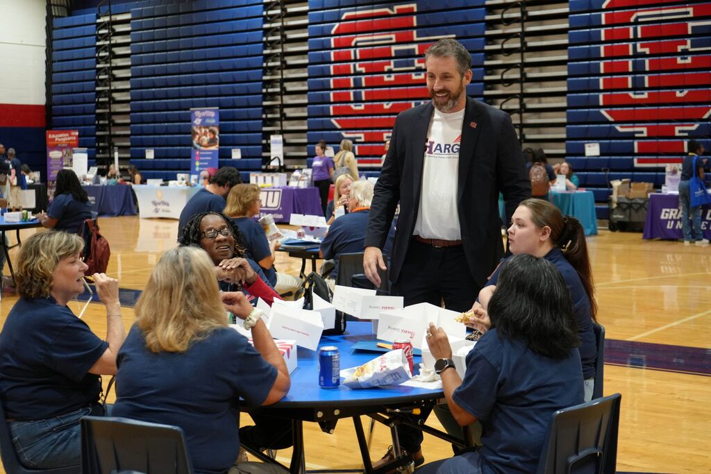 Assistant Superintendent Laughing with Group of Teachers at Lunch