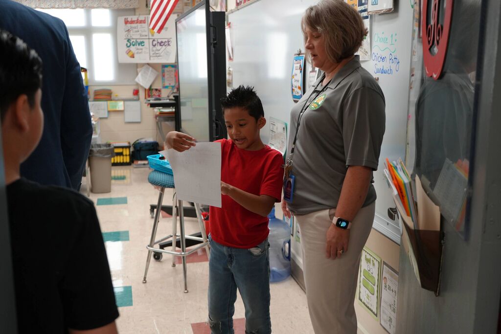 Student reading with Teacher