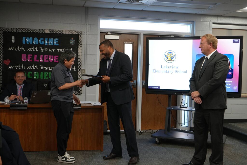 Tussing Support Staff Member of the Year, receiving award from Superintendent