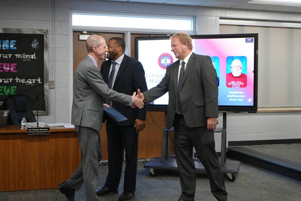 Colonial Heights Middle School Teacher of the Year, shaking hands with School Board Chair