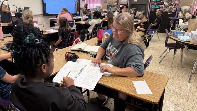 Teacher helping student with work