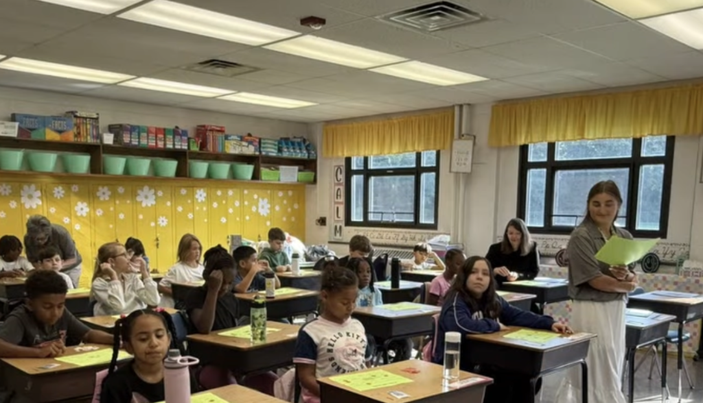 Teacher Walking around room giving assessment
