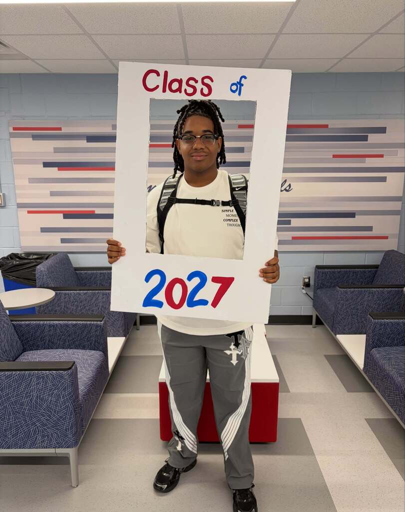 Senior boy posing in photo frame