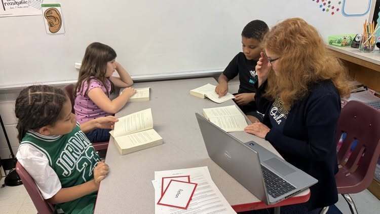students reading a book