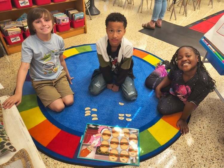 students playing matching game on colorful carpet