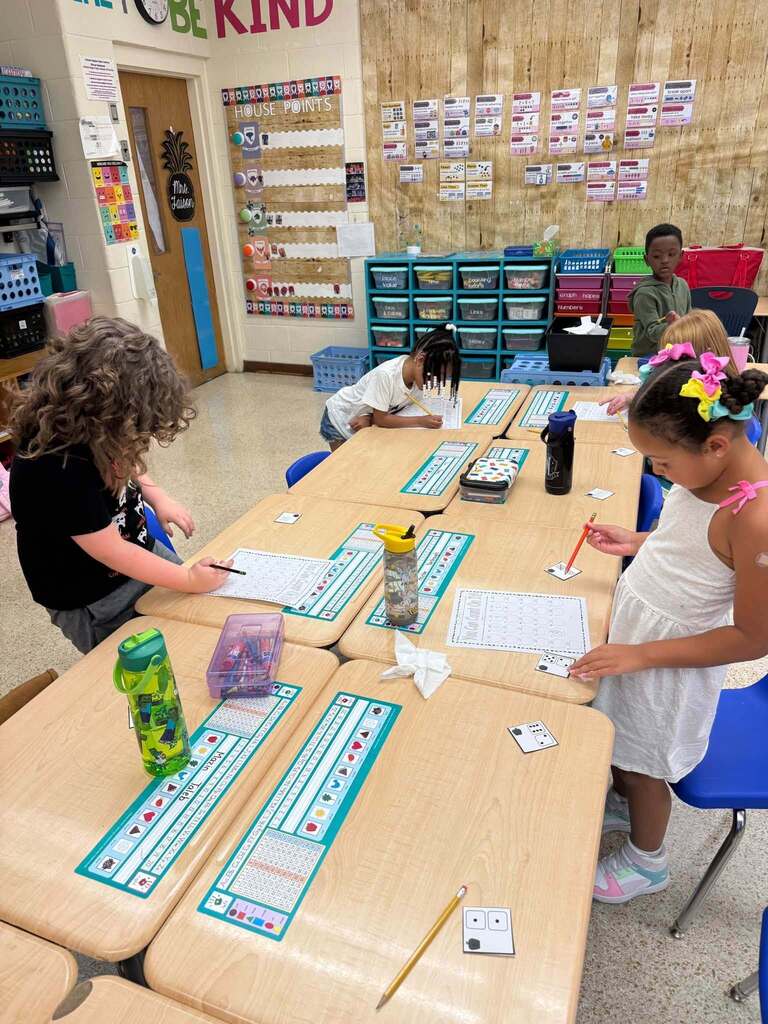 Students working on worksheet while standing and writing and sorting