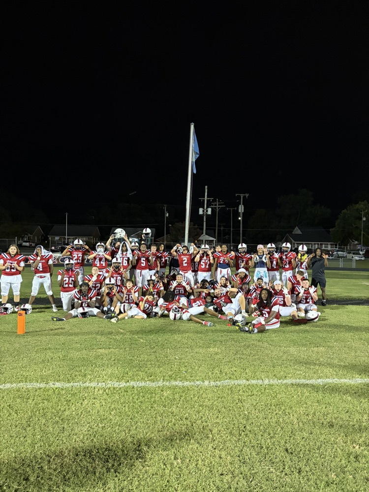 colonials football team picture with victory flag