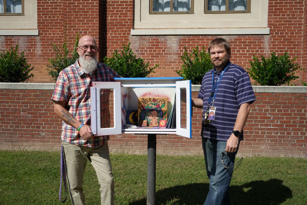Teachers posing with Open doored little free art gallery
