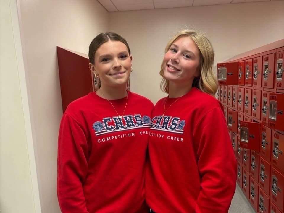 Girls in matching red sweatshirts for twin day