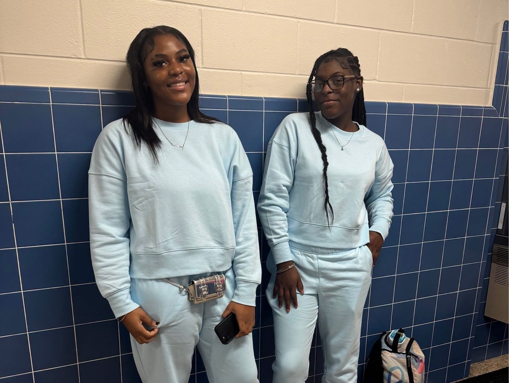 Girls dressed in matching blue twin outfits for twin day