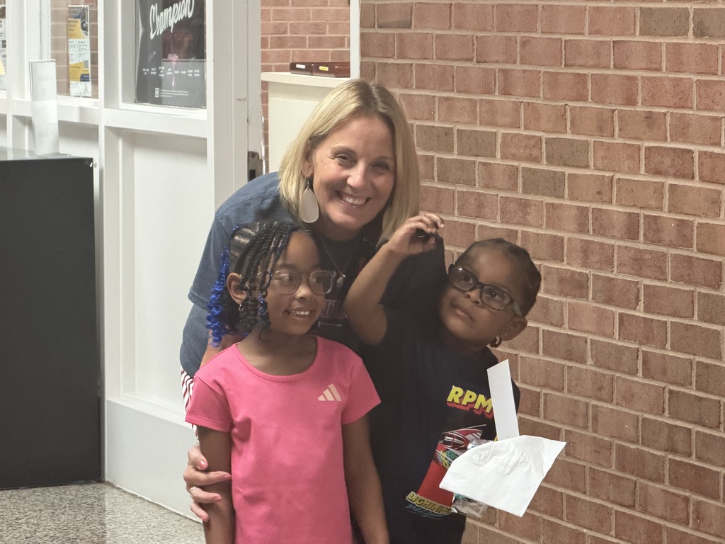 Family resource staff member with smiling children