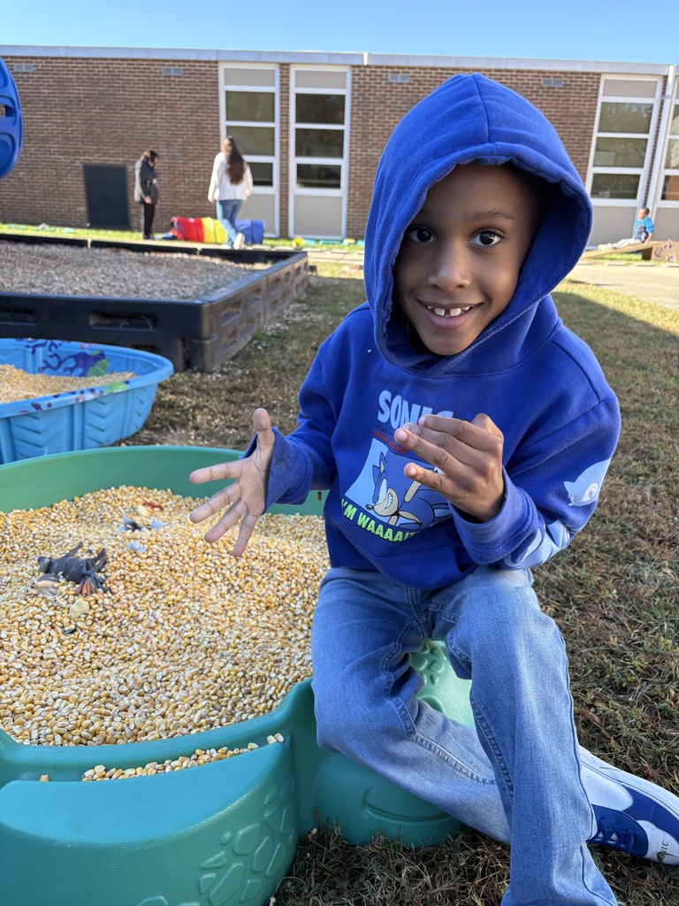 Boy sitting on the edge of a corn pit