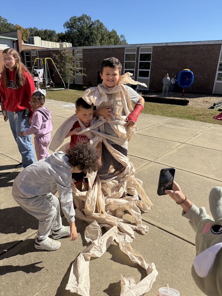 Children wrapping up as mummies