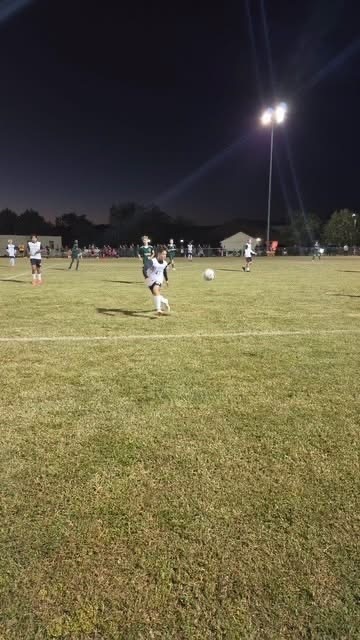 Boys on the Soccer field running after a ball