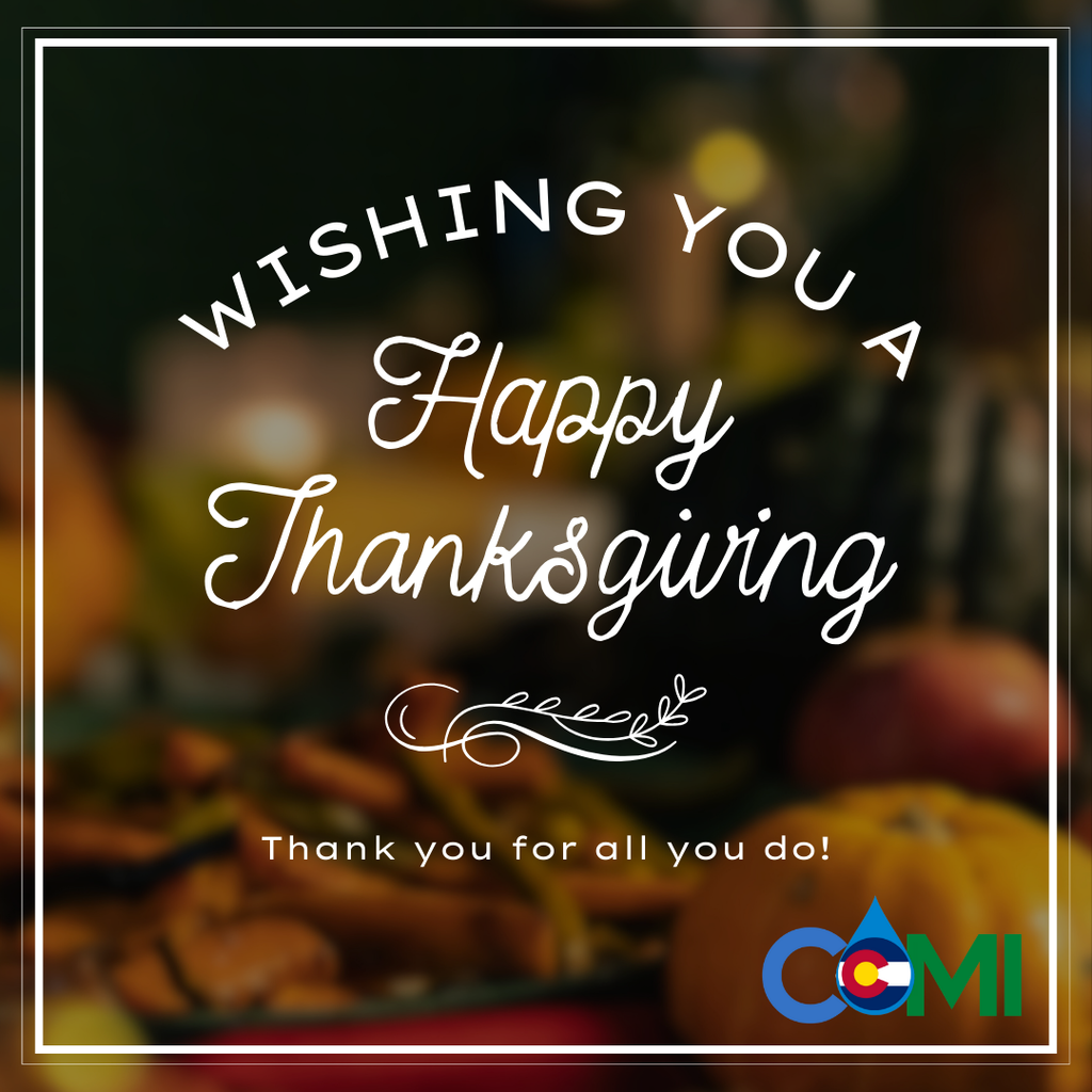 An image of a Happy Thanksgiving e-card with the text "WISHING YOU A Happy Thanksgiving" and "Thank you for all you do!". The card features a blurry background of autumnal food items and a logo for "COMI" with the Colorado state flag colors.