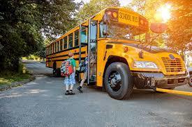 School Bus with children loading. This form is for bus referrals.