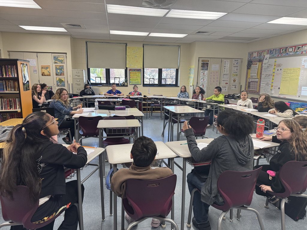 children in a class room sitting at desks
