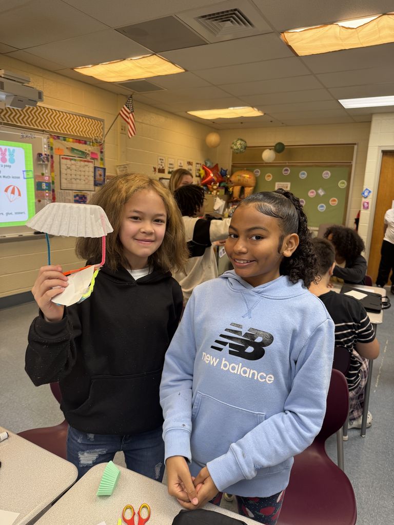 2 students posing together with their parachute