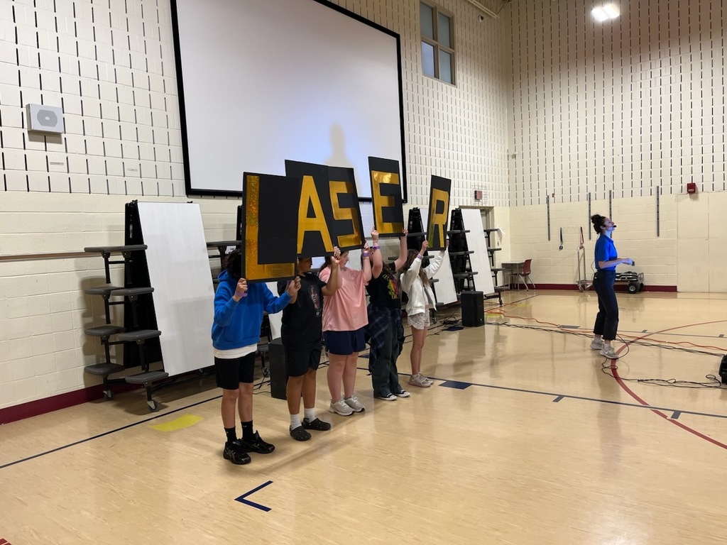 students spelling laser with signs