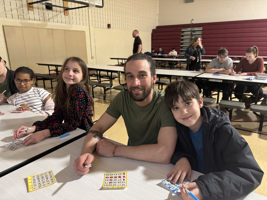 students and parents sitting together smiling
