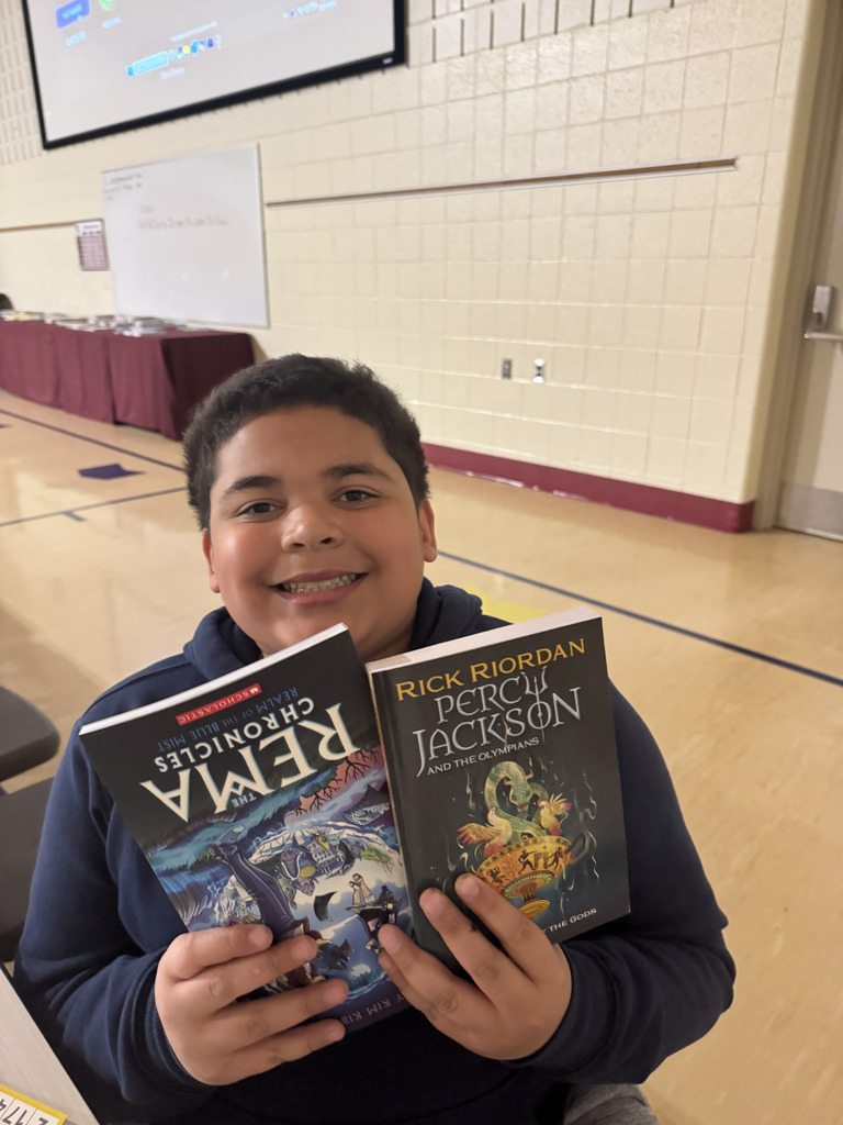 student holding books 