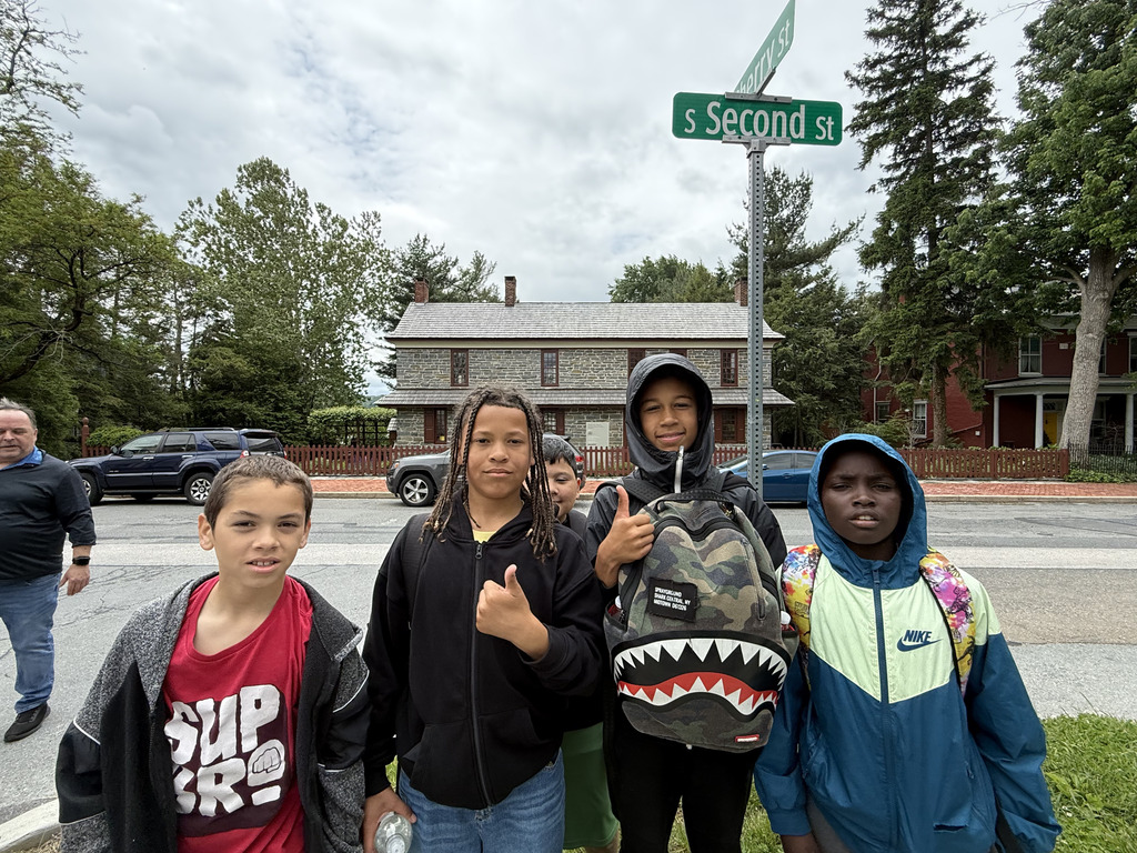  students standing in front of a road sign