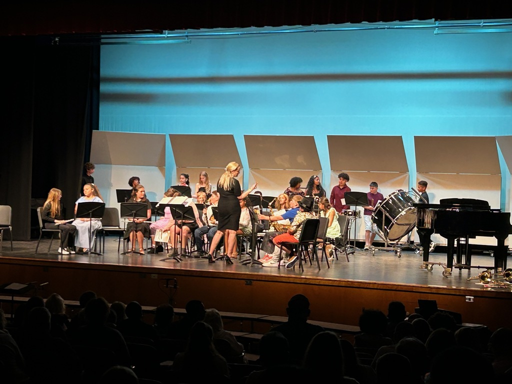 student preforming in the band on a stage