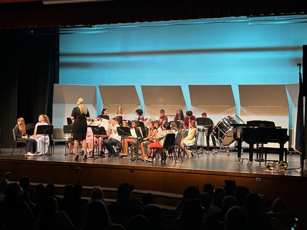 student preforming in the band on a stage