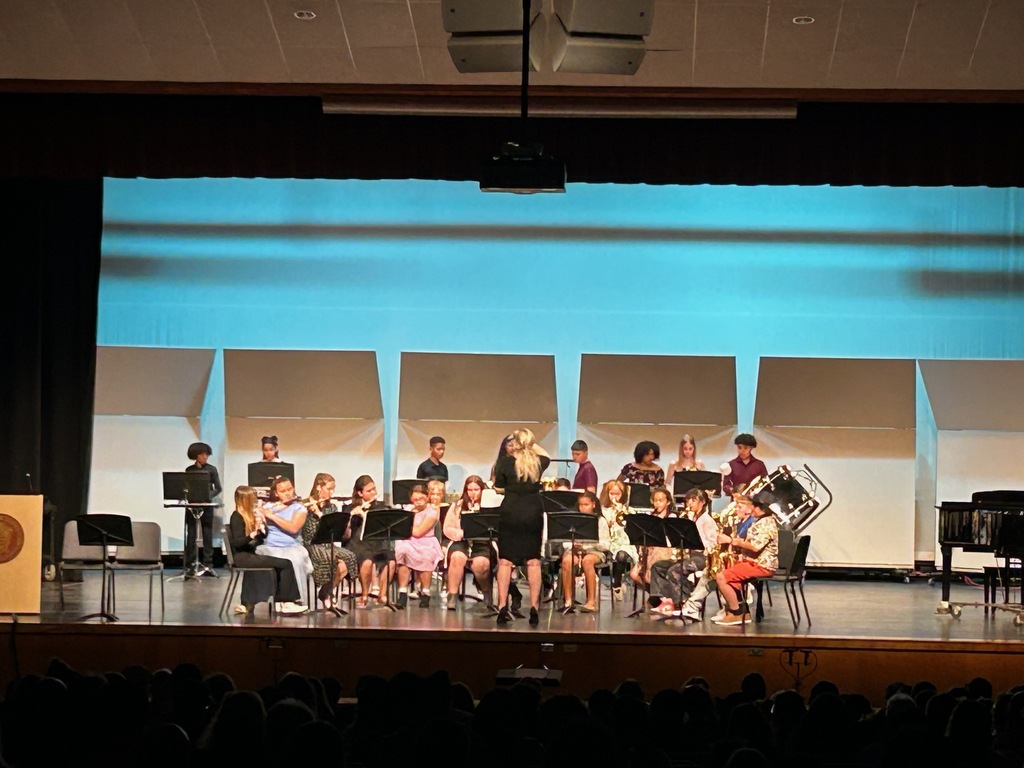 student preforming in the band on a stage