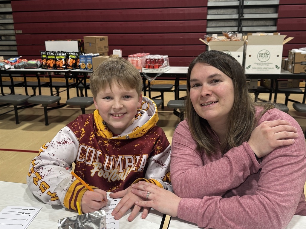 student and parent smiling sitting together