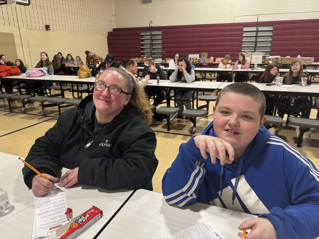 student and parent smiling sitting together