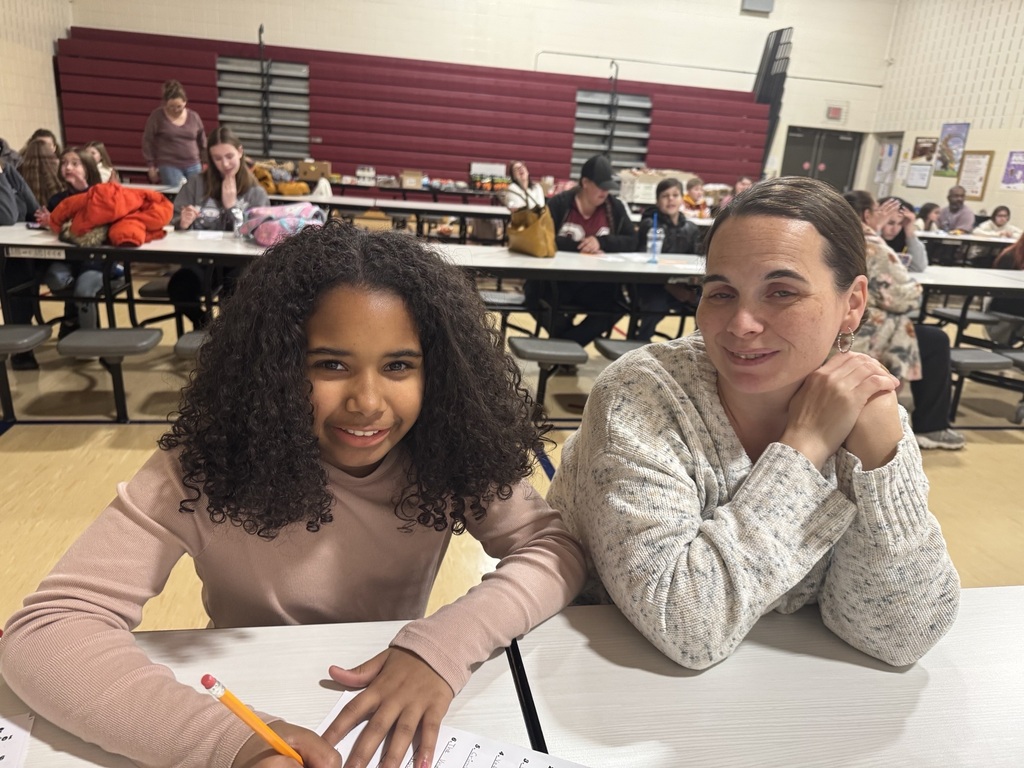 student and parent smiling sitting together