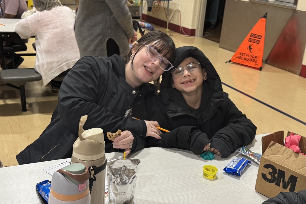 student and parent smiling sitting together