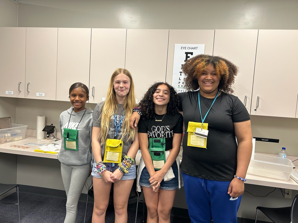 Students standing in a group smiling 