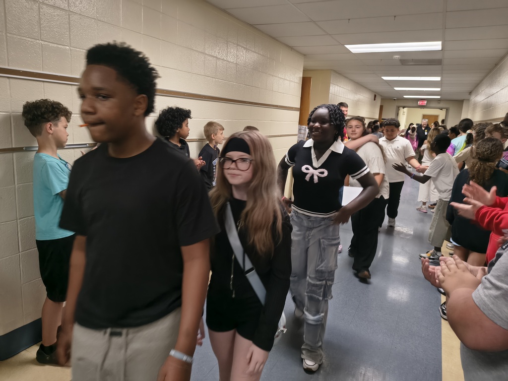 Students waljking the halls clapping
