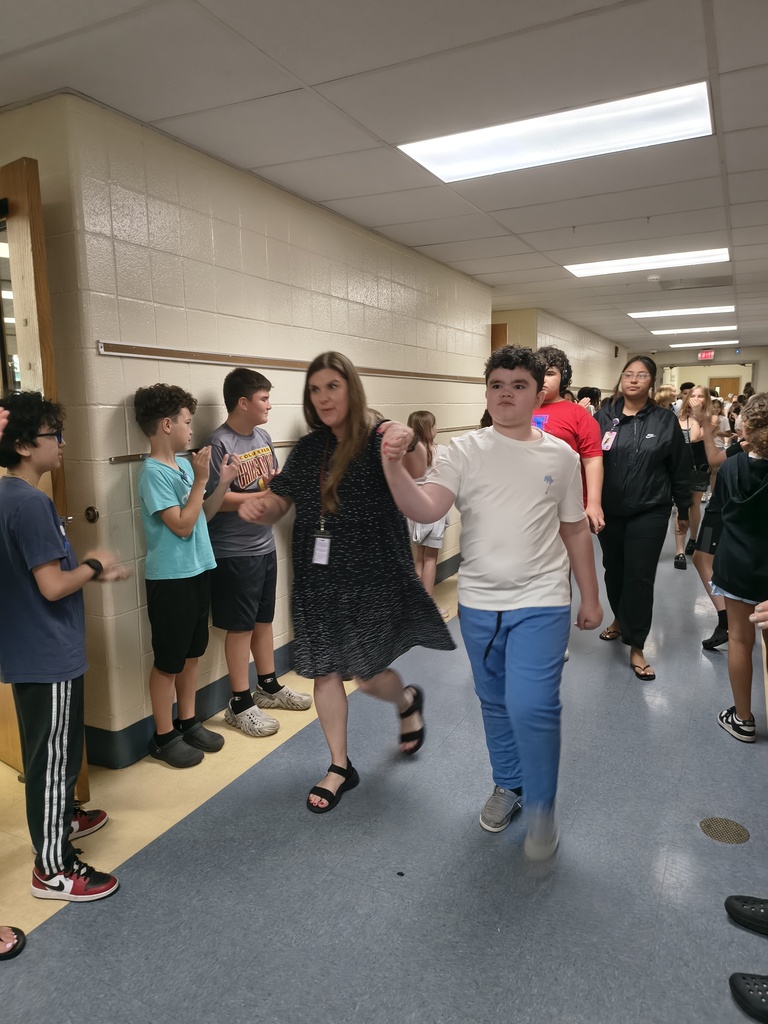 Students waljking the halls clapping