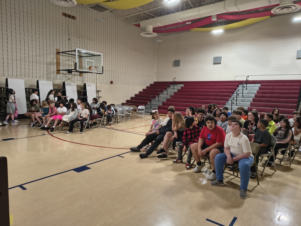 students sitting in the gym