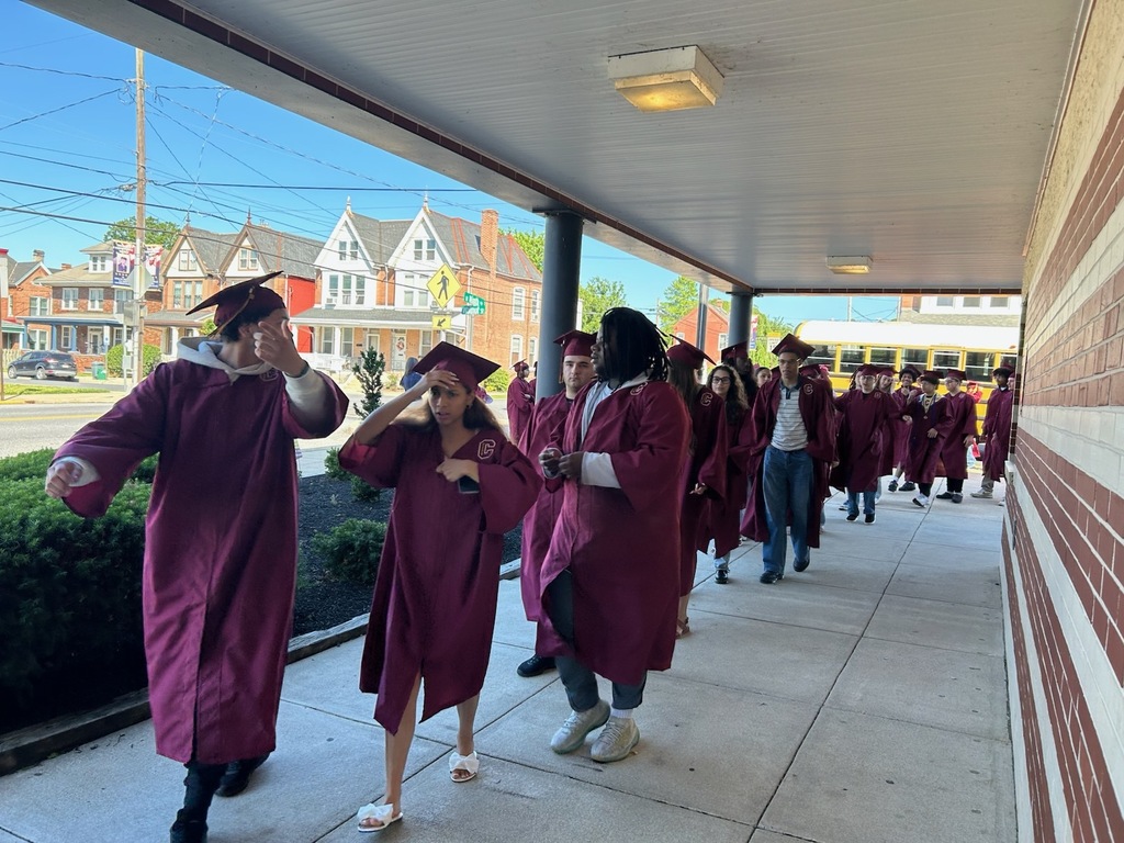graduate walking outside of the school