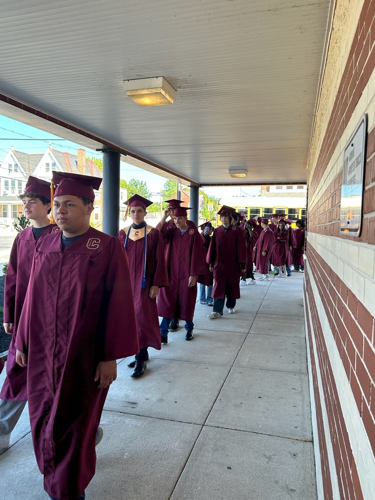 graduate walking outside of the school