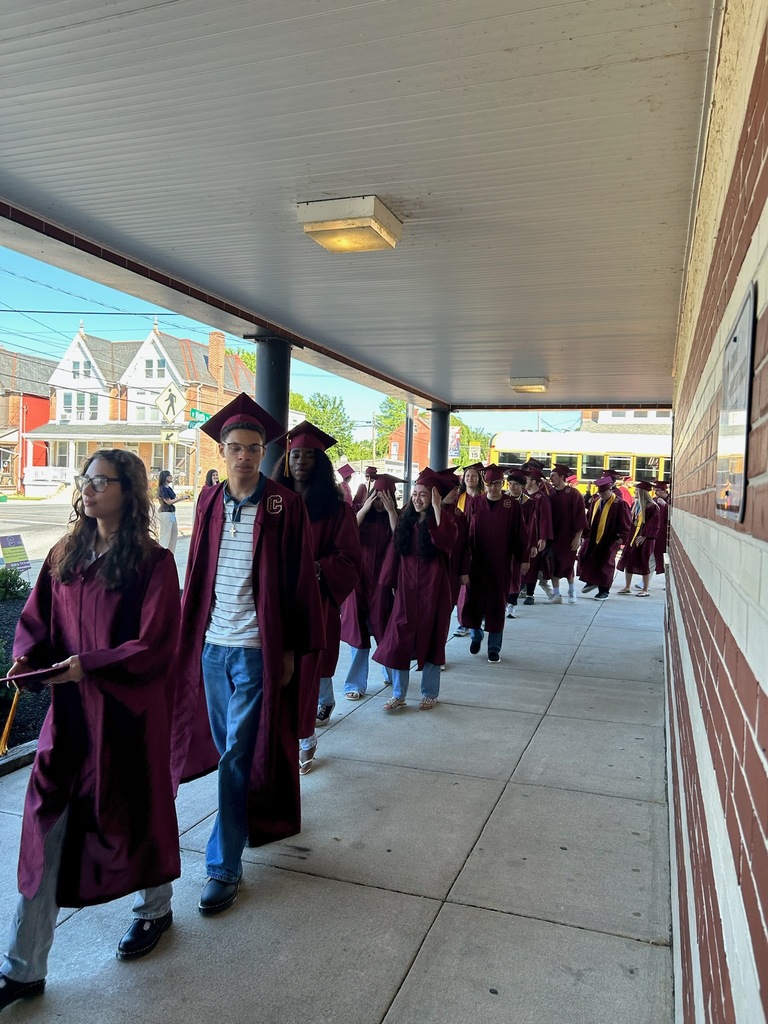 graduate walking outside of the school