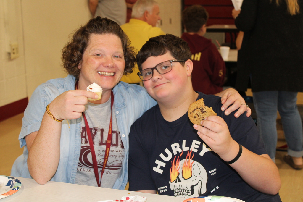 parent and student smiling together with food