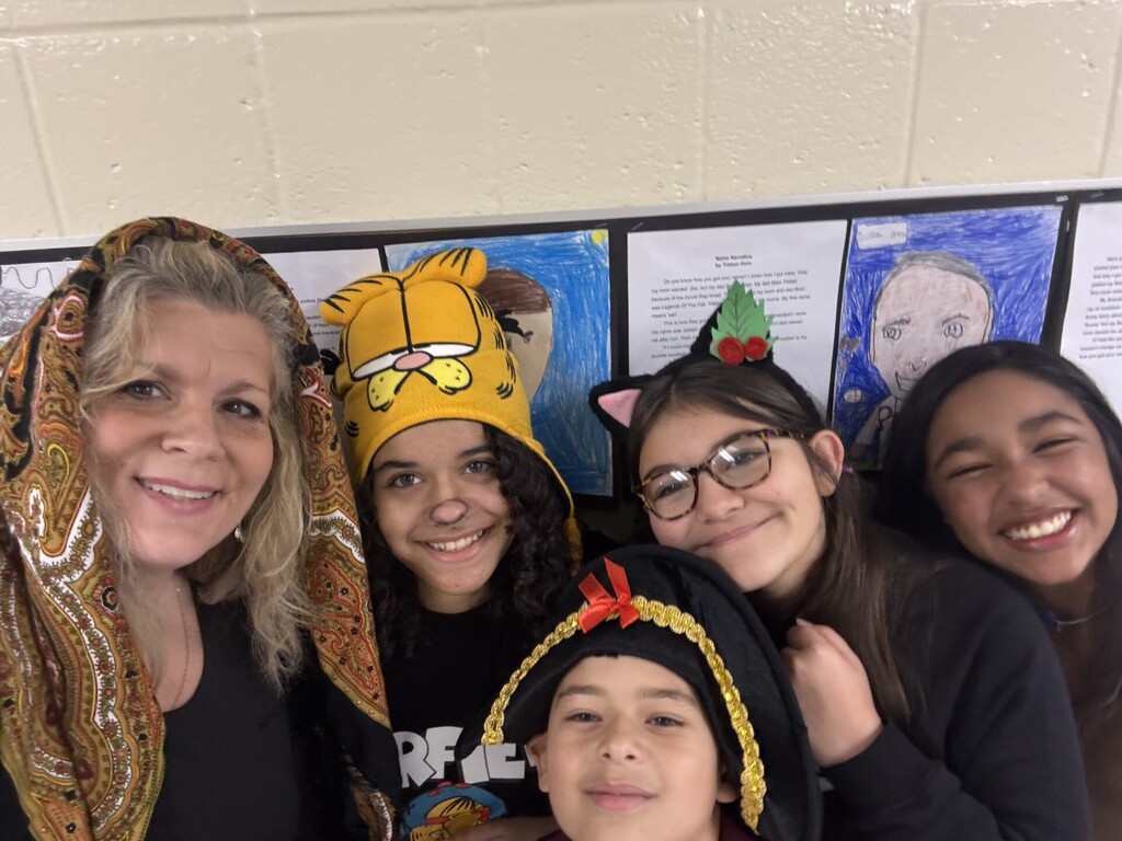 staff and students posing in costumes during storybook character day.