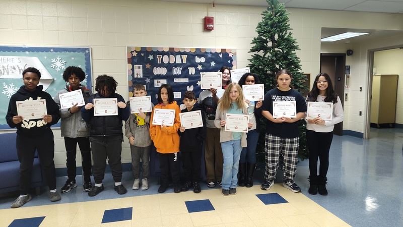 students holding their certificates