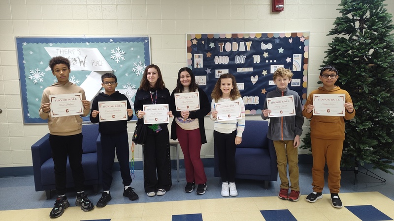 students showing off their certificates