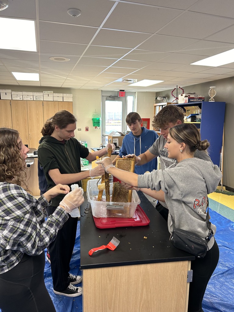 Horticulture students extracting honey