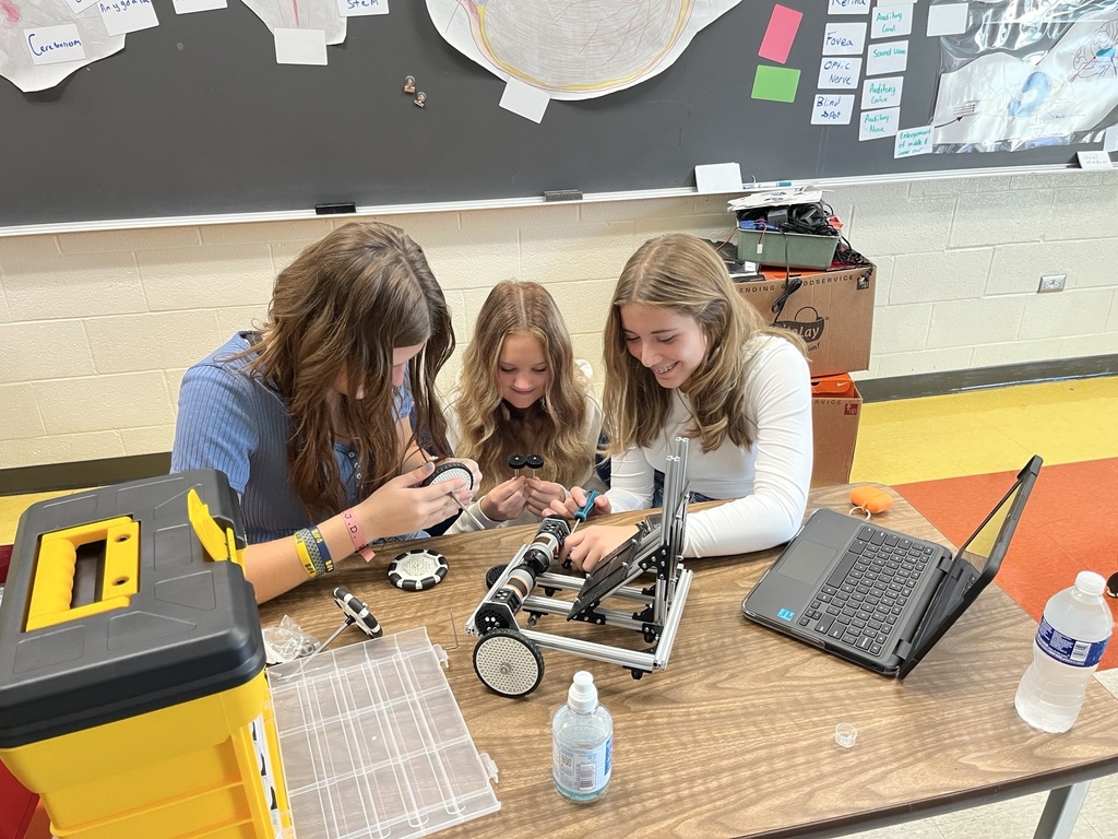 8th grade girls working on their robot