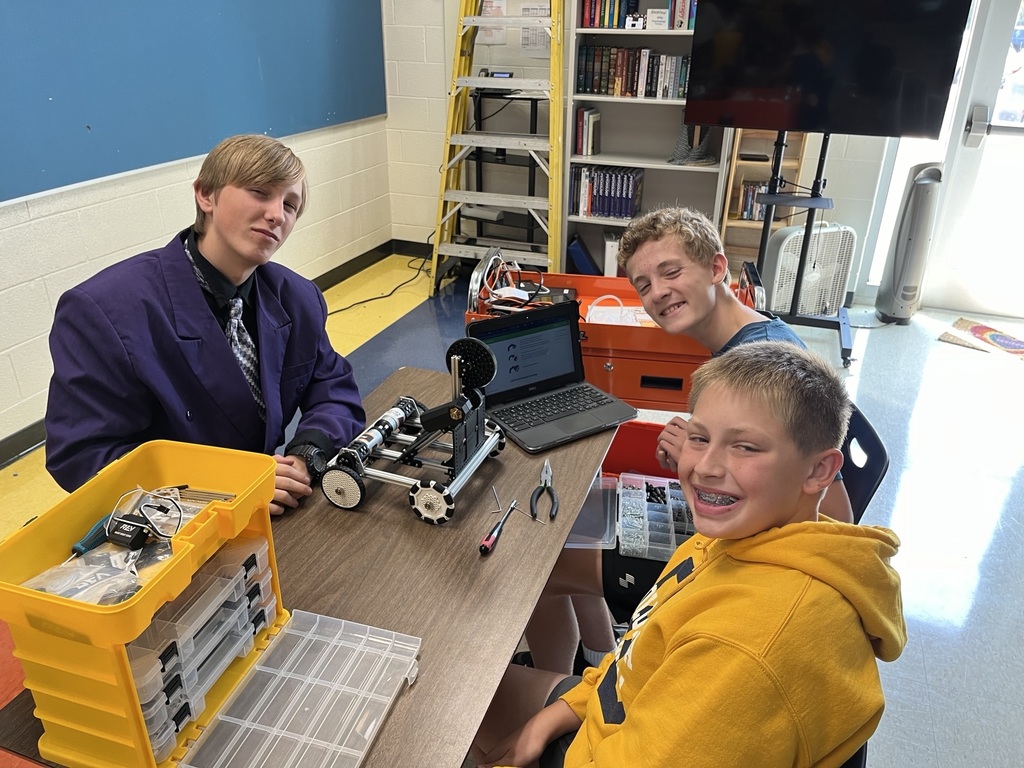 8th grade boys working on their robot